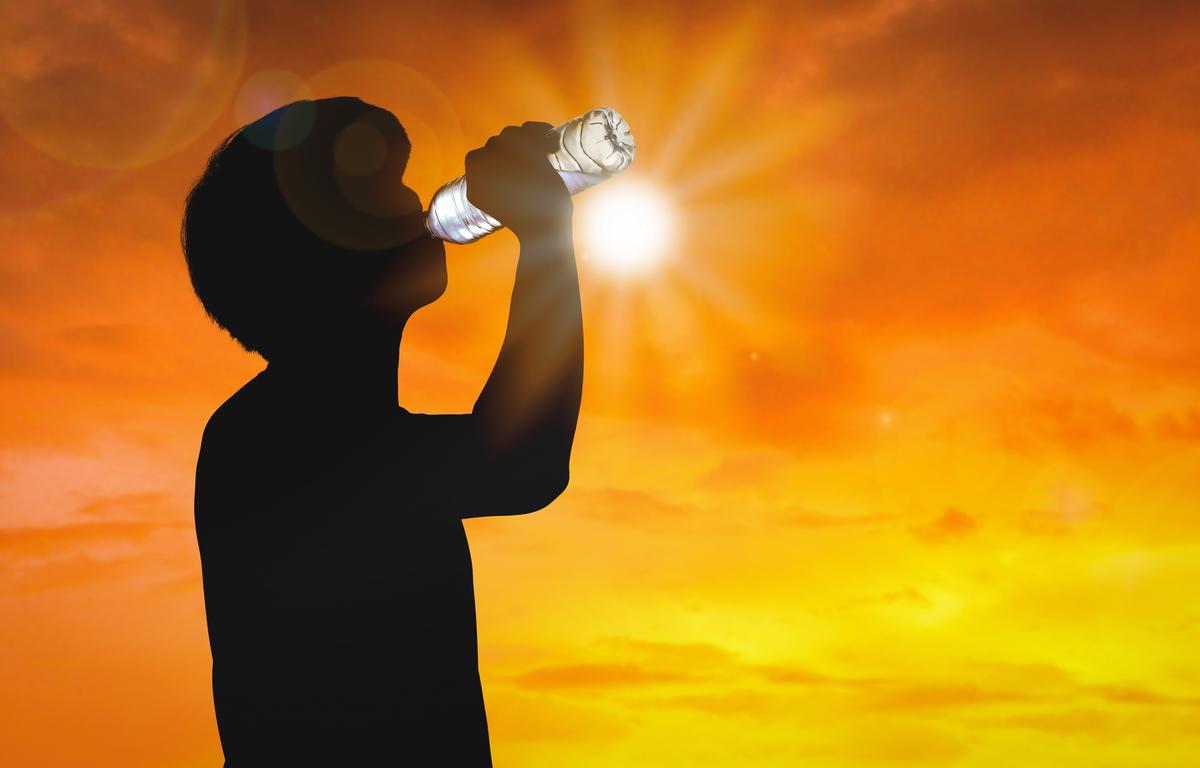Man Drinking Water in Sun