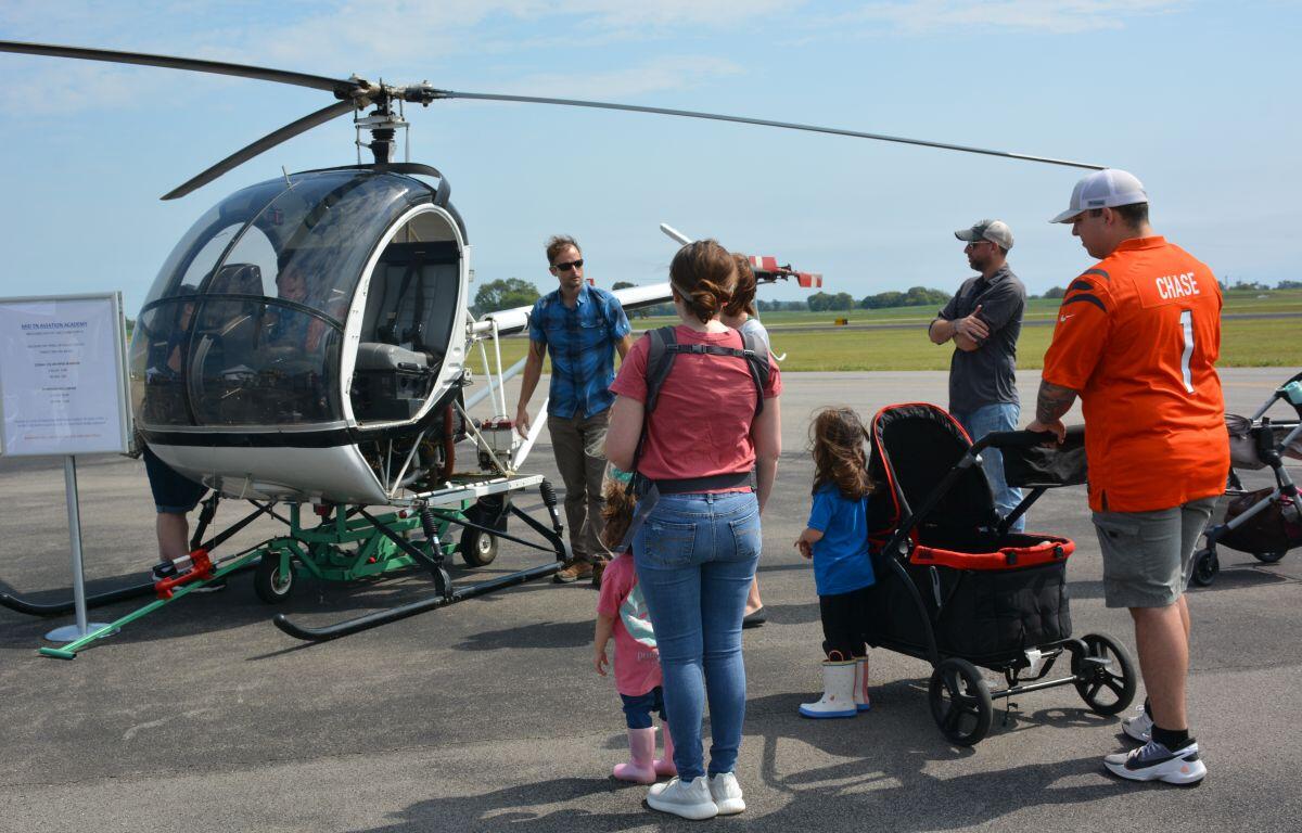 Visitors enjoy looking over one of the helicopters at Just Plane Fun Days at the Clarksville Regional Airport on, Sep. 24, 2022. (Lee Erwin).