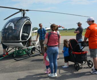Visitors enjoy looking over one of the helicopters at Just Plane Fun Days at the Clarksville Regional Airport on, Sep. 24, 2022. (Lee Erwin).
