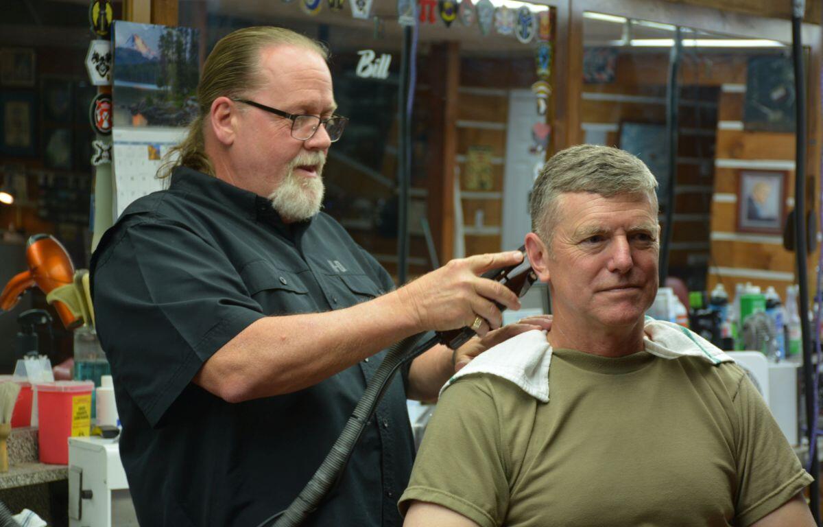 Ronnie Ward at Bo's Barber Shop giving Major General JP McGee a haircut on Jul. 17, 2023. (Lee Erwin)