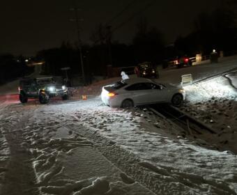 Several members of the Clarksville Jeep Crew help recover a car that slid off the road near Trenton Road around midnight on Monday, Jan. 15, 2024. (Crystal Liberatore, contributed)