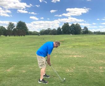 Golfer practicing on the driving range at Mason Rudolph Golf Course. (Christian Brown)