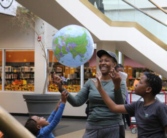 A Sci-Fi & Fantasy Expo attending family reacts to an inflatable "Earth" suspended in the air through the demonstration of the Bernoulli's principle by APSU students and their Professional Mad Scientist, Bryan Gaither, at the CMC Public Library on Nov. 2, 2024. (Daniela Thomas/APSU)