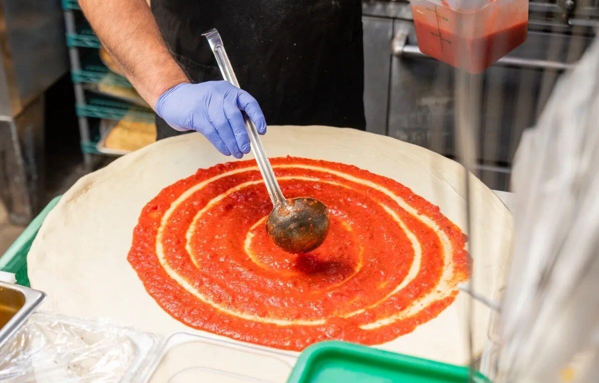 Adding the sauce at Michael's Pizza and More. (Contributed)