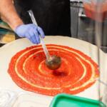 Adding the sauce at Michael's Pizza and More. (Contributed)