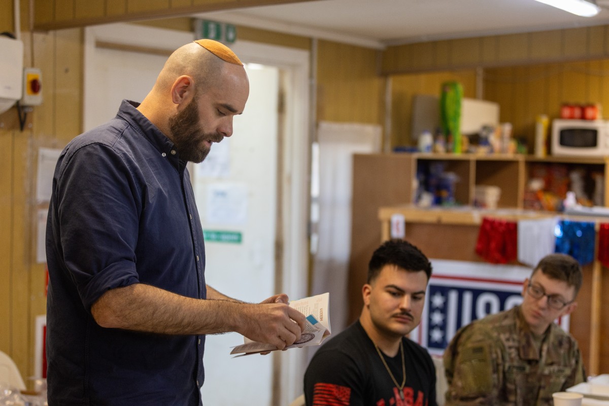 U.S. Army Rabbi Adam Strater reads from the Haggadah during a Seder dinner on Erbil Air Base, Iraq, April 19, 2025. (U.S. Army photo by Capt. Andrew Lightsey IV)