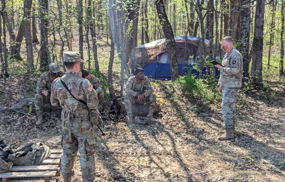 Chaplain (Maj.) Michael Dawson preaches to soldiers during a field training exercise, providing spiritual support and guidance in a tactical environment. (U.S. Army photo by Staff Sgt. David Shaffer)