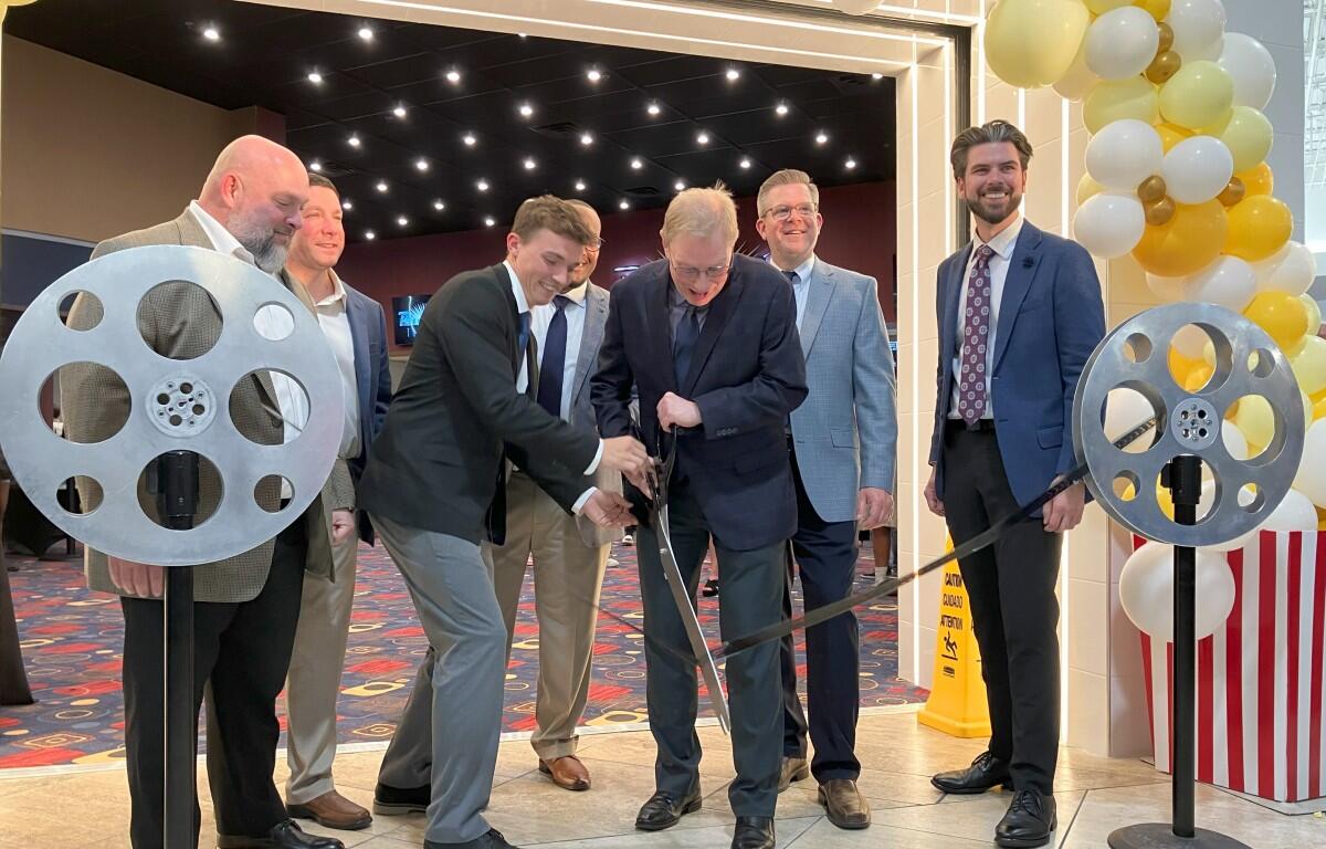 Derek Almada and Cory Jacobson handle the "film cutting" at the Phoenix Theatres grand opening on May 22, 2025. (Chris Smith)