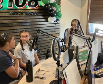 Students join Kyle King and Tiffany Hill on the air on Q108 for Q-Up the Classroom radiothon for Teachers Warehouse on July 24, 2025. (Chris Smith)