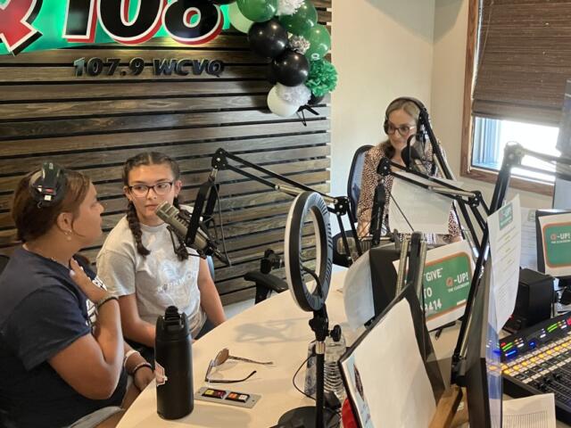 Students join Kyle King and Tiffany Hill on the air on Q108 for Q-Up the Classroom radiothon for Teachers Warehouse on July 24, 2025. (Chris Smith)