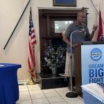 President Vester Carney, the head of the Benevolent Lodge, speaking at the Blue South BBQ on July 19.