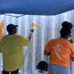 Volunteers at the Hands On and Loaves and Fishes Mural Painting on July 24