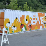 Partially-finished mural on shipping container at Loaves and Fishes on July 24