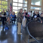 Cathy Kolb, president of the Red River Republican Women's club, speaking during the Red River Republican Women wine tasting on July 25.
