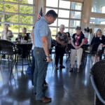 County Mayor Wes Golden praying during the Red River Republican Women wine tasting on July 25.
