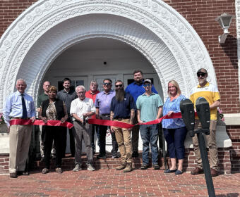 Ribbon cutting revealing the restored Public Square arch on July 31.