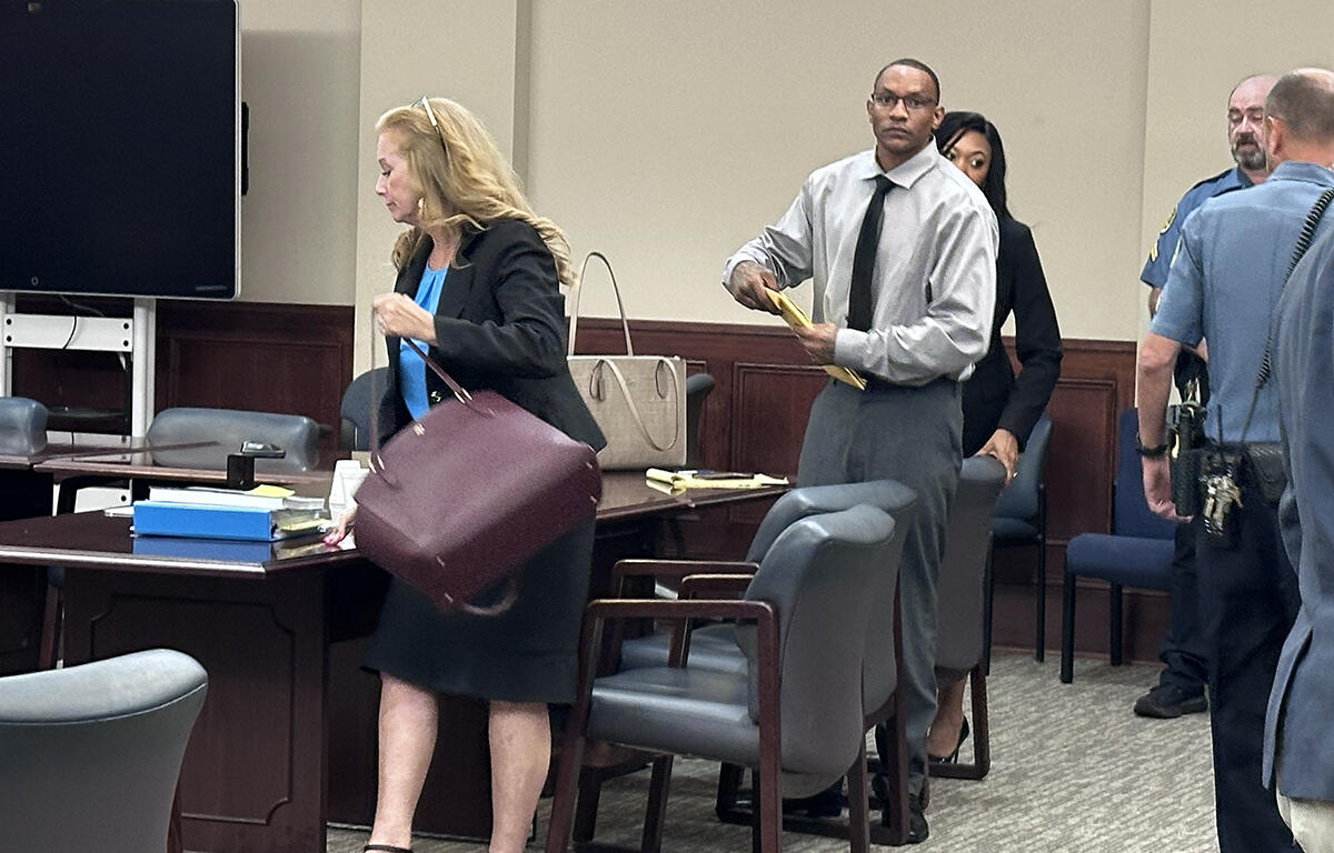 Timothy Lebrone Williams (right) and Stephanie Ritchie Mize, Williams' defense attorney, packing up to leave after another mistrial was declared on August 4.