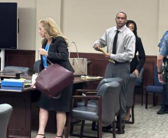 Timothy Lebrone Williams (right) and Stephanie Ritchie Mize, Williams' defense attorney, packing up to leave after another mistrial was declared on August 4.