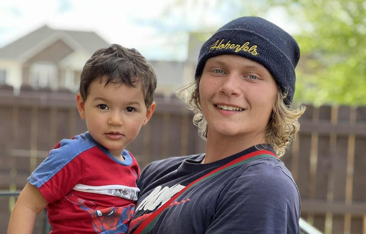 Noah Peterson, right, holds his little brother, Zach Peterson. (Contributed, John Patterson)