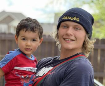 Noah Peterson, right, holds his little brother, Zach Peterson. (Contributed, John Patterson)