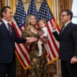 Rep. Matt Van Epps, R-Tenn, left, takes part in a ceremonial swearing-in with Speaker Mike Johnson, R-La., Thursday, Dec. 4, 2025, in Washington. Holding the Bible is Van Epps' wife, Meg Wrather, and their daughter, Amelia Van Epps. (AP Photo/Kevin Wolf)