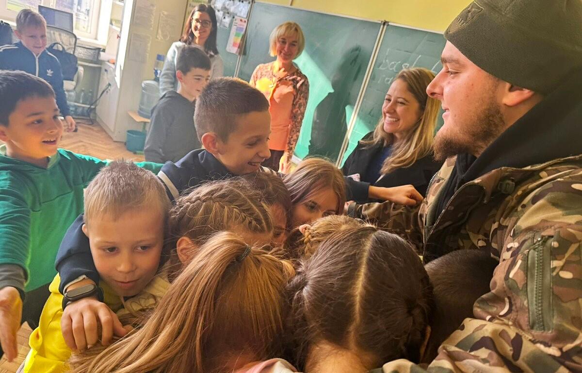 Andrea Lee, back right, and a wounded soldier visit a school in Ukraine for a child's birthday party in 2024. (Andrea Lee, contributed)