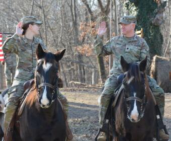 Cpl. Savannah Gibson-Sateen, left, and Lt. Col. Philip Bowling during the reenlistment ceremony at Veteran Equine Time on Dec. 17, 2025. (Lee Erwin)