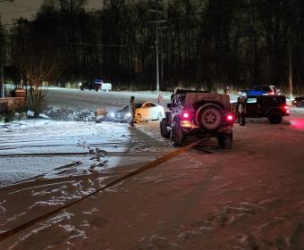 Police and Jeep drivers assist a vehicle during a previous winter storm in Clarksville. (CPD, contributed)