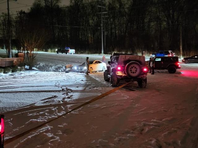 Police and Jeep drivers assist a vehicle during a previous winter storm in Clarksville. (CPD, contributed)