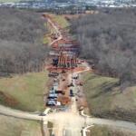 Aerial photo of progress on Spring Creek Parkway as of March 25, 2026. Shown is the bridge over Spring Creek, looking southeast toward Wilma Rudolph Boulevard, with Walmart at left and Kohls at right. (City of Clarksville, contributed)