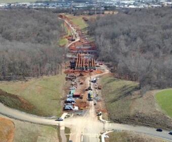 Aerial photo of progress on Spring Creek Parkway as of March 25, 2026. Shown is the bridge over Spring Creek, looking southeast toward Wilma Rudolph Boulevard, with Walmart at left and Kohls at right. (City of Clarksville, contributed)