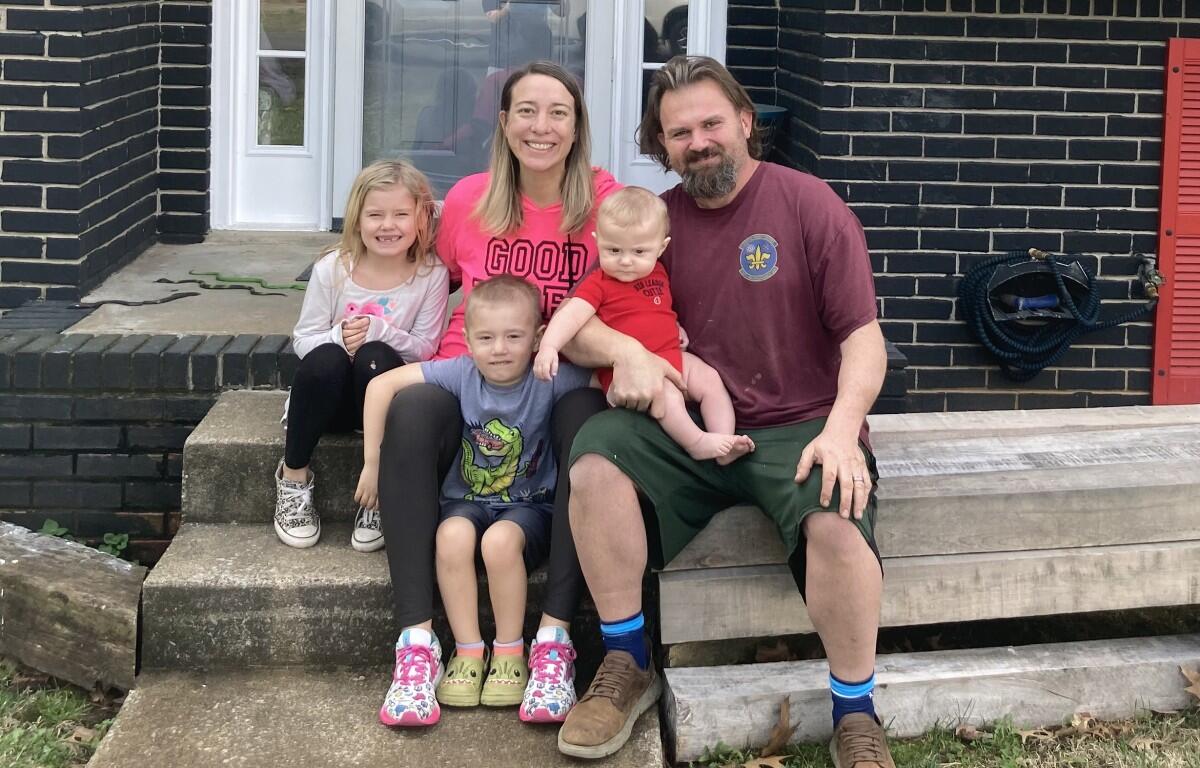 The Thompsons sitting out front of their home on Gardendale Lane. (Christian Brown)
