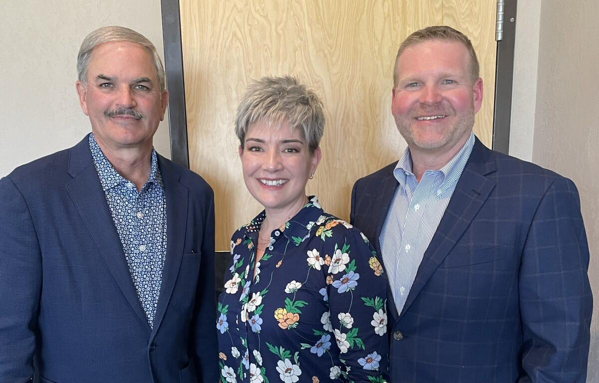 Charlie Koon, left, with Stephanie and Chris Travis.