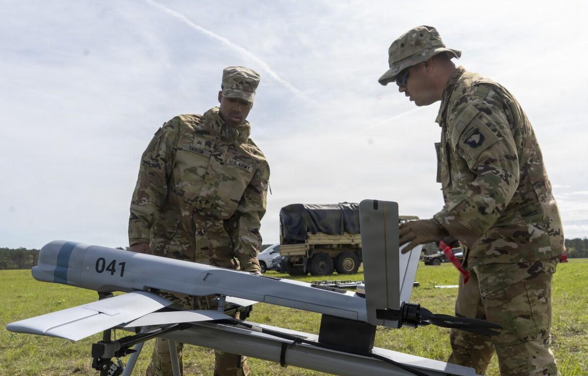 Staff Sgt. Brandon Livingston-Stephenson and Sgt. Abduel Taylor, assigned to 101st Airborne Division, set up the Aevex Atlas precision guided drone system at the Joint Readiness Training Center, Fort Polk, Louisiana, April 5, 2026. (U.S. Army photo by Spc. Mariam Diallo)