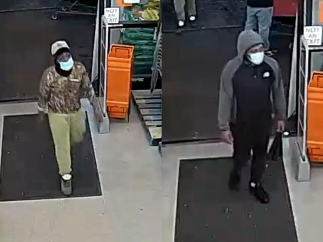 Two masked men enter a store through the entrance; left man wears camo hoodie and beige pants, white cap.
