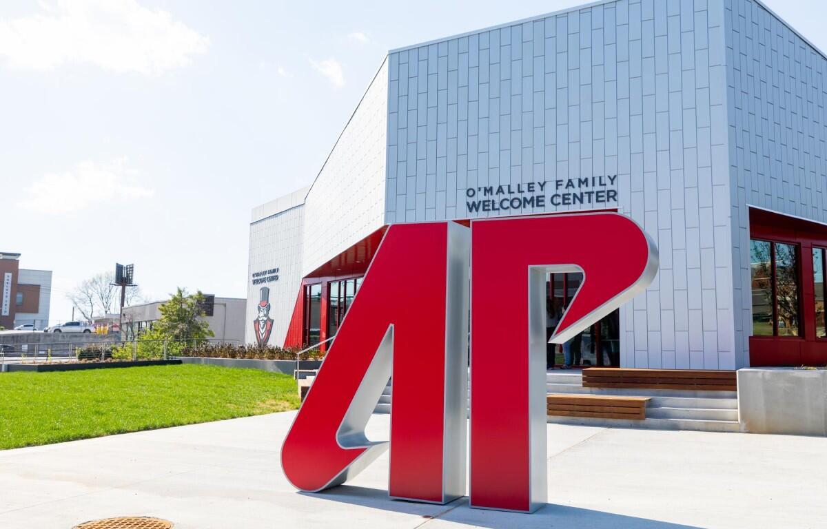 Large red '4D' sculpture in front of a modern white building with 'O'Malley Family Welcome Center' sign