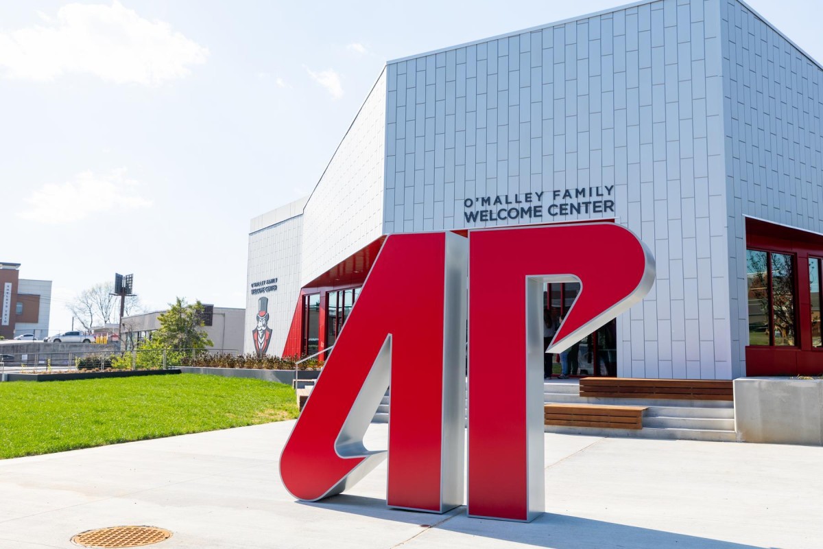 Large red '4D' sculpture in front of a modern white building with 'O'Malley Family Welcome Center' sign