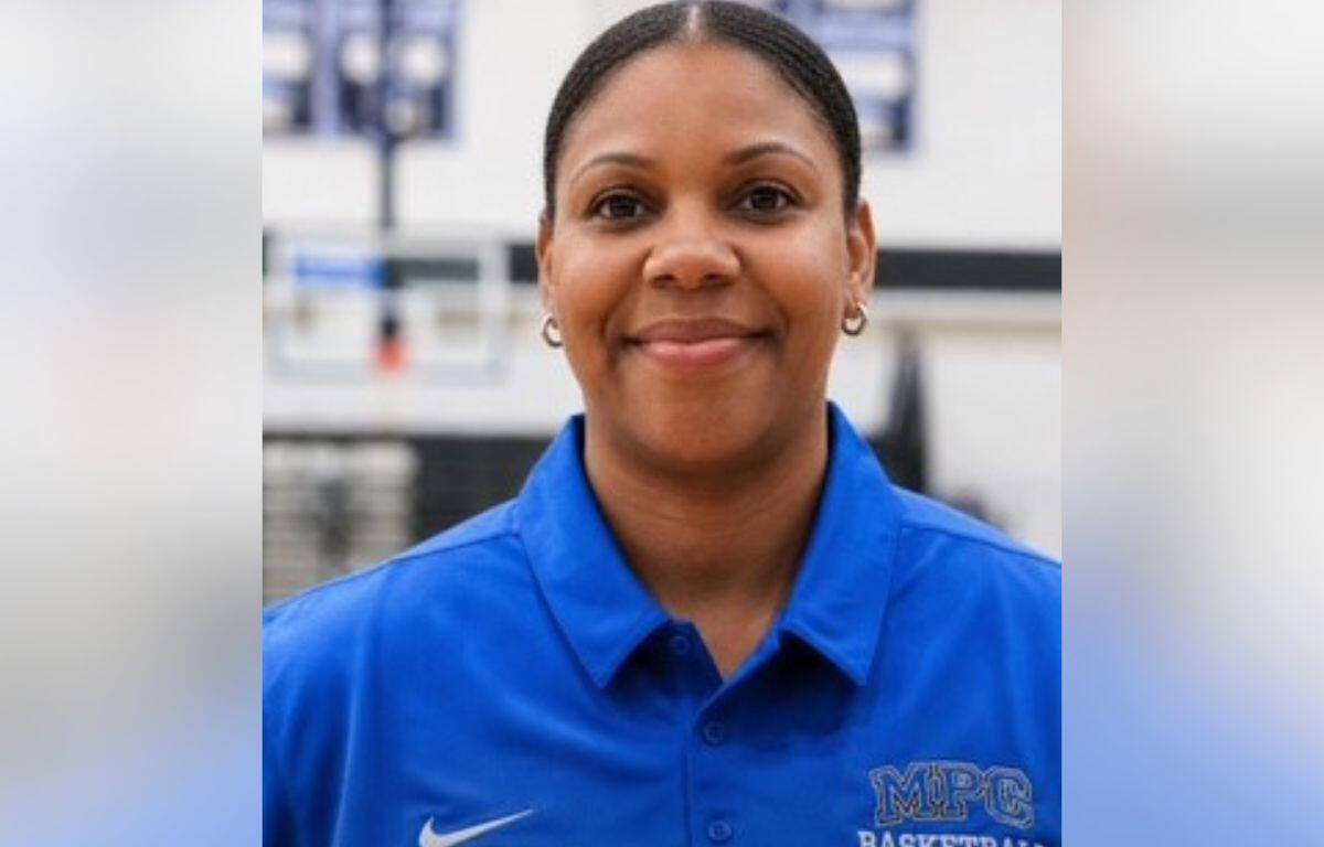Portrait of a smiling woman in a blue MPC Basketball polo, facing the camera.