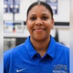 Portrait of a smiling woman in a blue MPC Basketball polo, facing the camera.