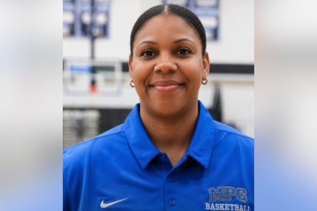 Portrait of a smiling woman in a blue MPC Basketball polo, facing the camera.