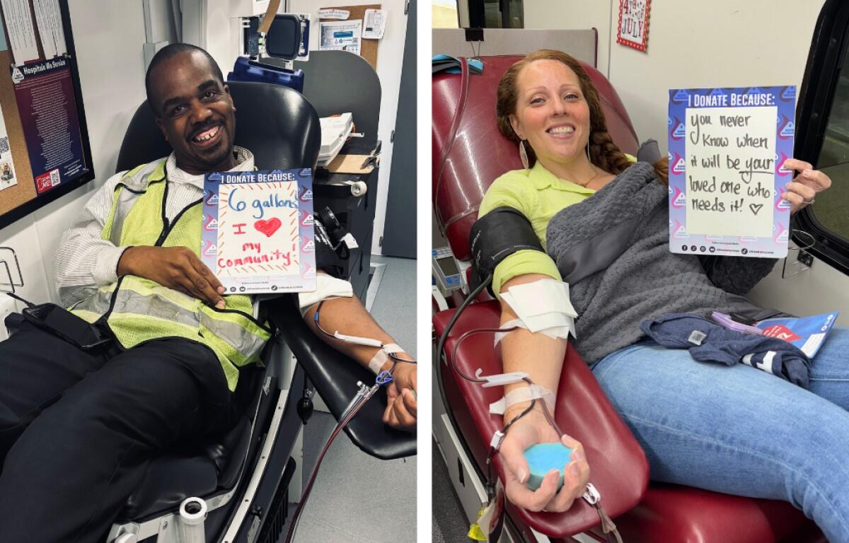 Two blood donors in a clinic, smiling and holding signs about why they donate.