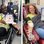 Two blood donors in a clinic, smiling and holding signs about why they donate.
