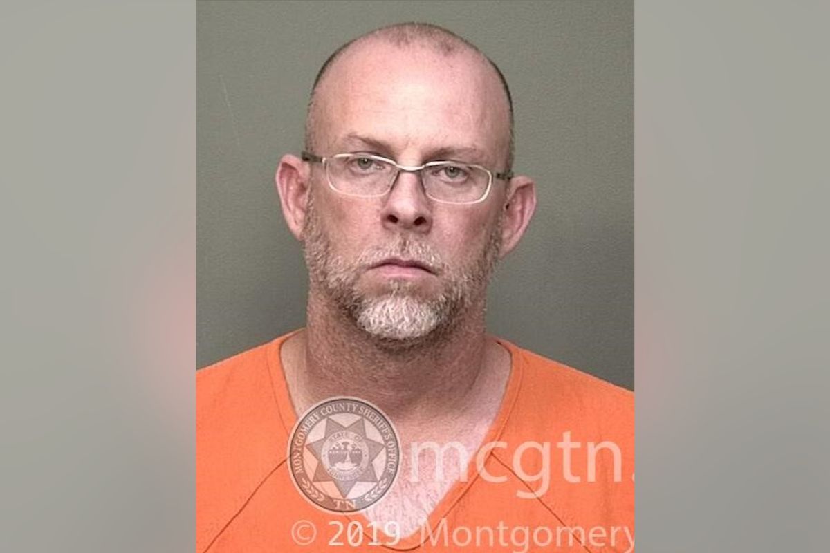 Mugshot of a bald man with glasses wearing an orange jumpsuit, facing the camera with a neutral expression; watermark from Montgomery County Sheriff's Office visible.