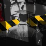 Graduate in cap and gown seen from behind with yellow-and-black caution tape across the foreground.