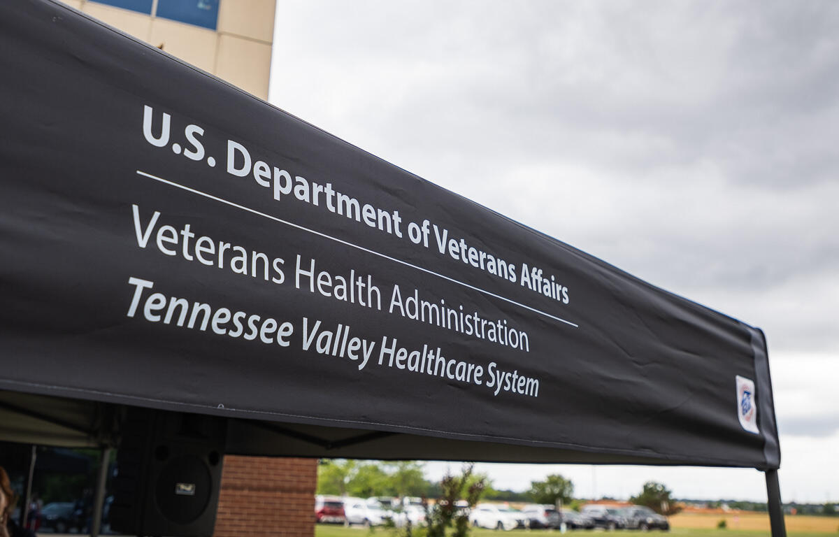 Outdoor tent with a black canopy displaying the text: 'U.S. Department of Veterans Affairs', 'Veterans Health Administration', 'Tennessee Valley Healthcare System' in white letters