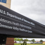 Outdoor tent with a black canopy displaying the text: 'U.S. Department of Veterans Affairs', 'Veterans Health Administration', 'Tennessee Valley Healthcare System' in white letters