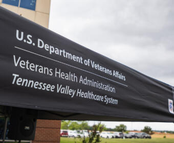 Outdoor tent with a black canopy displaying the text: 'U.S. Department of Veterans Affairs', 'Veterans Health Administration', 'Tennessee Valley Healthcare System' in white letters