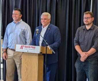 Montgomery County mayor candidates Wes Golden, left, and Isaac Greenwood, right, with host Jay Albertia, center, at the Chamber of Commerce Meet the Candidates event on July 15, 2026. (Chris Smith)
