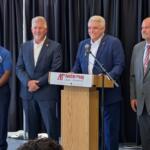 Montgomery County sheriff's candidates, from the left, Dexter Mines, Johnny Ransdell and, at right, Mike Oliver, with Jay Albertia, at microphone, at the Chamber of Commerce Meet the Candidates event on July 15, 2026. (Chris Smith)