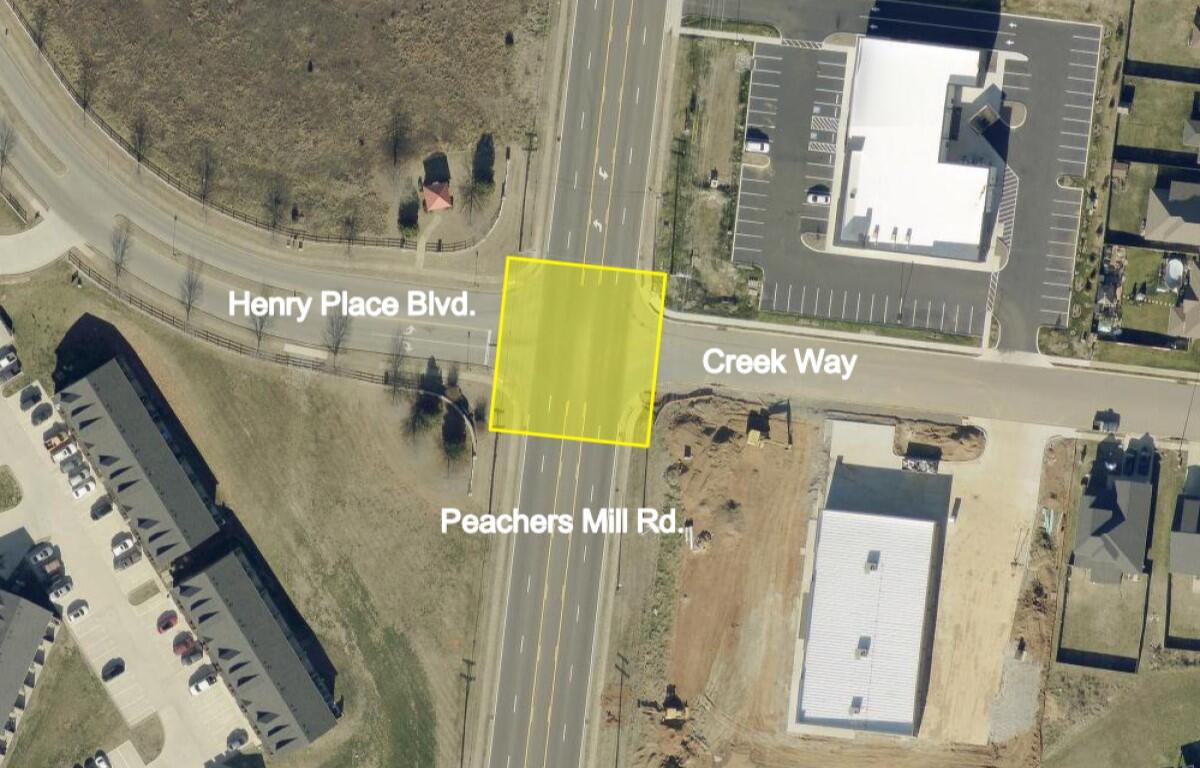 Aerial view of an intersection where Henry Place Blvd meets Creek Way and Peachers Mill Rd; a yellow square marks a lot.